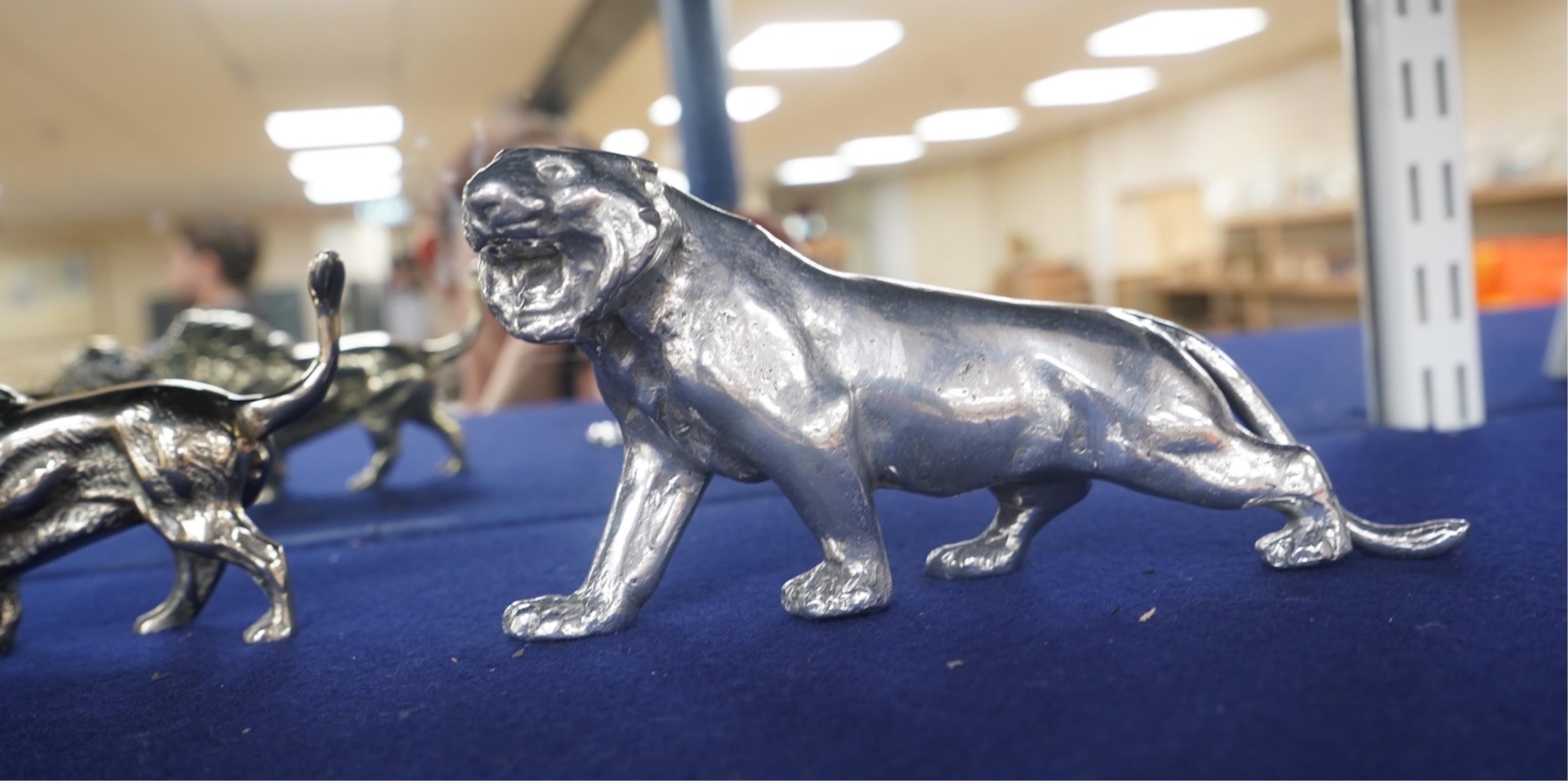 Four lion and big cat related brass and chrome car mascots/figures, consisting of two lions, a tiger and another, possibly a panther. Condition - fair, some losses to chrome.